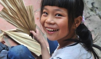 Laughing girl with a fan