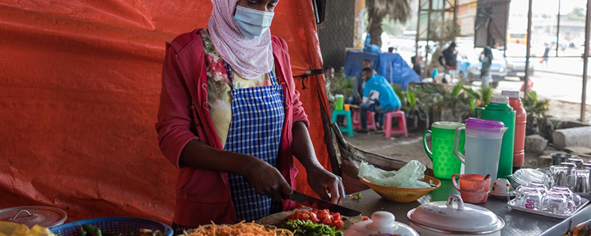 women at a street food stall