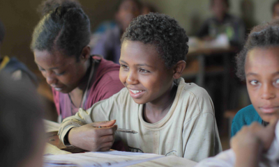 Children writing at a table