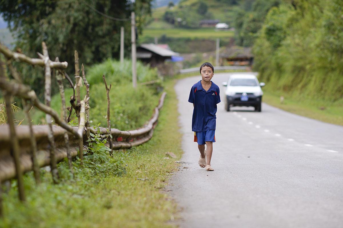 Young boy walking down the street