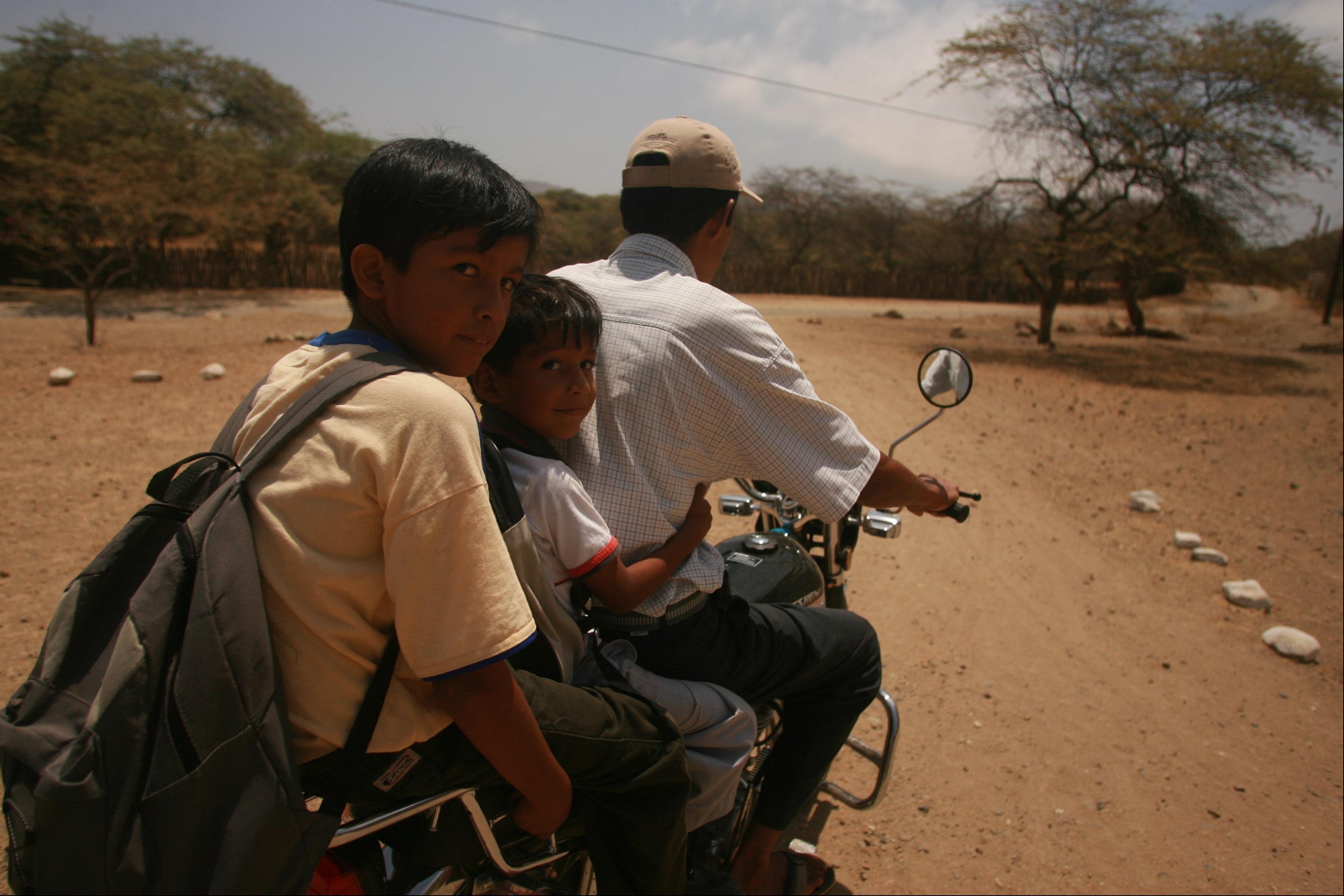 Father and two boys on a motorbike