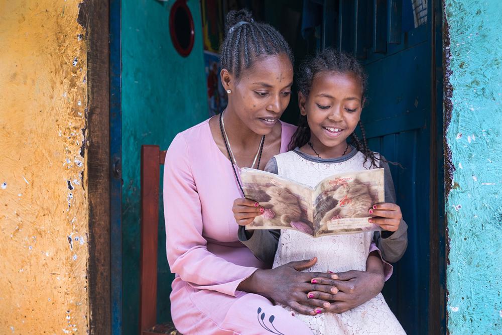 mother reading to her daughter