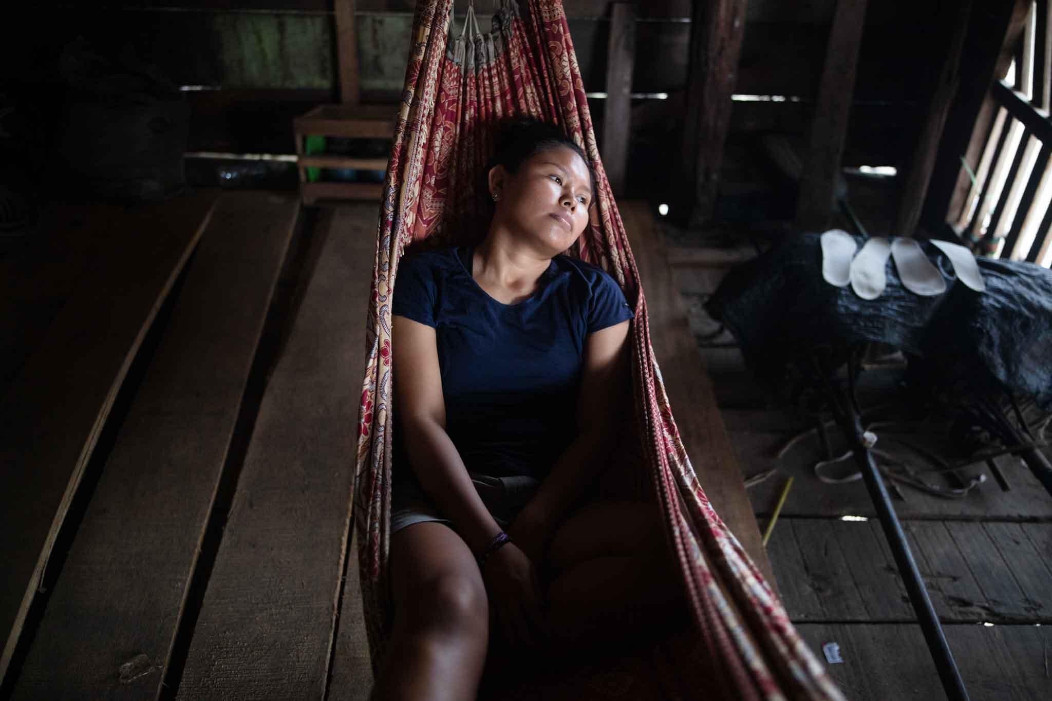 Peruvian women in a hammock looking sad